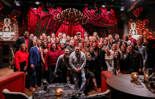 Gavin DeGraw poses with caregivers after a concert